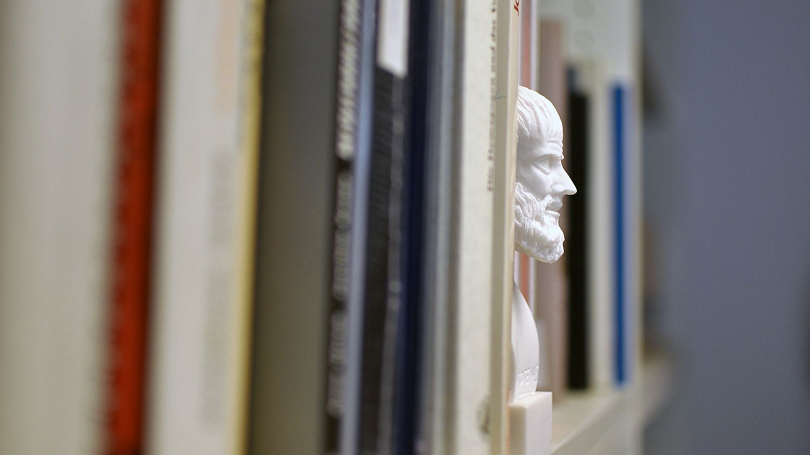 Statue on a bookshelf.