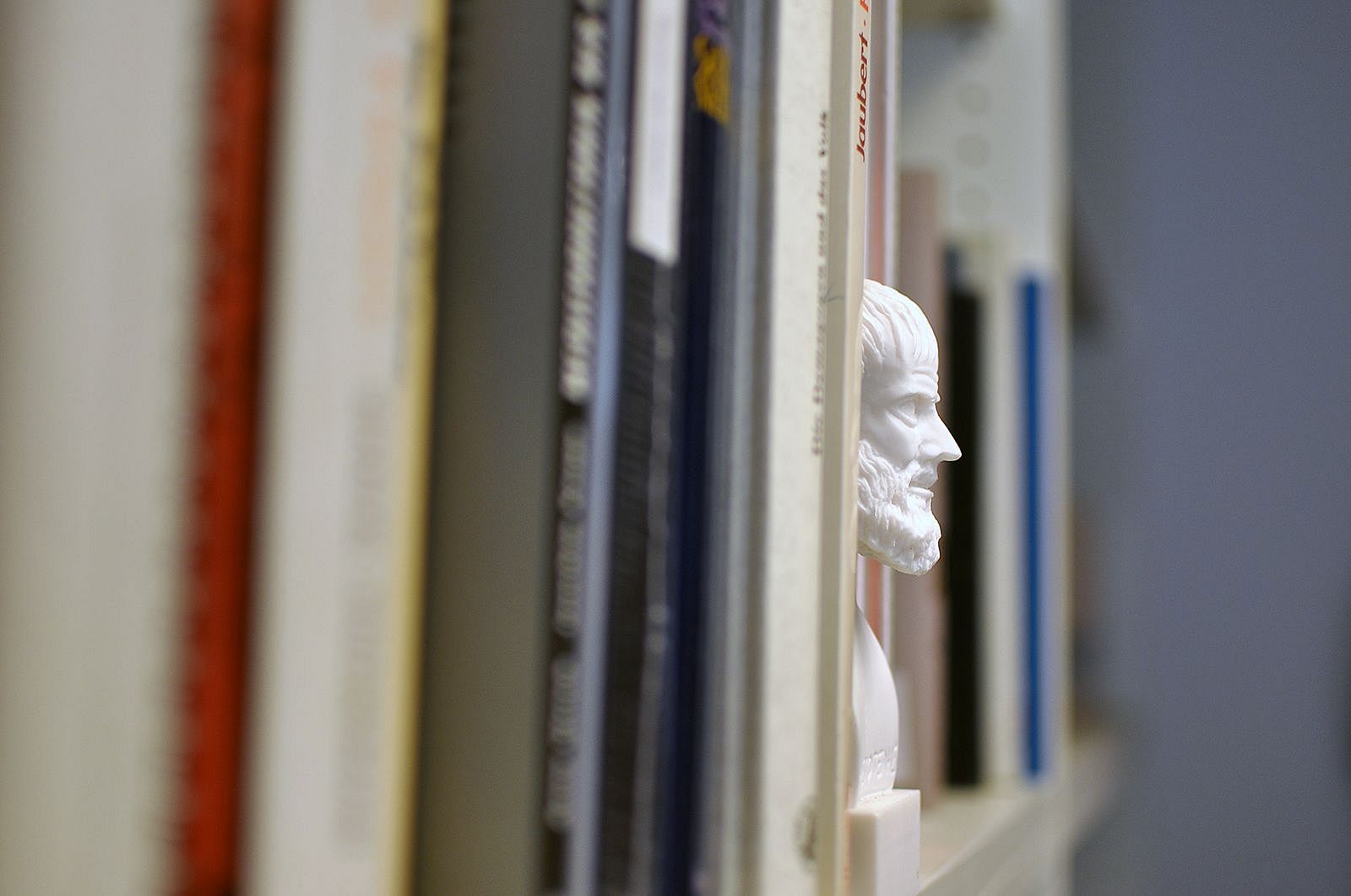 Statue on a bookshelf.